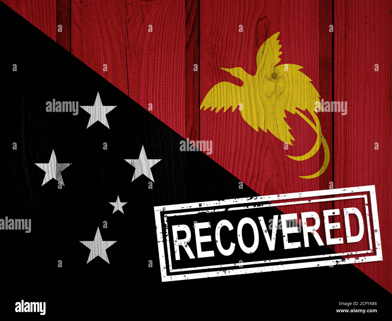 flag of Papua New Guinea that survived or recovered from the infections of corona virus epidemic or coronavirus. Grunge flag with stamp Recovered Stock Photo