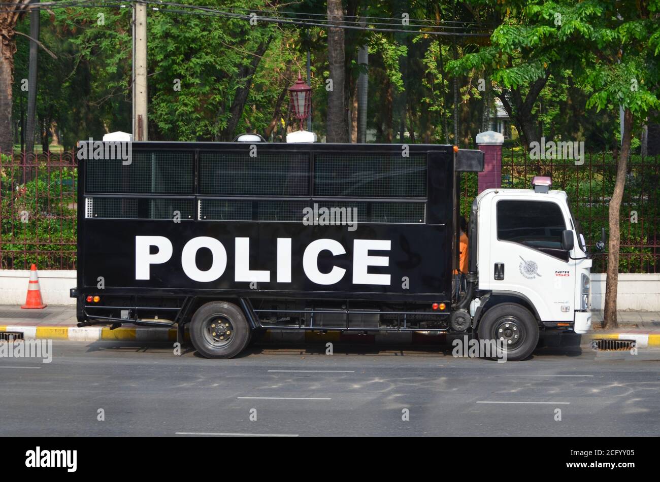 Black Police Prison Bus on the road of Bangkok. Stock Photo
