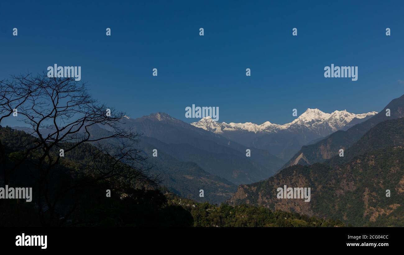 A panoramic view of Mt Kanchenjunga with first rays of sunlight falling on it Stock Photo