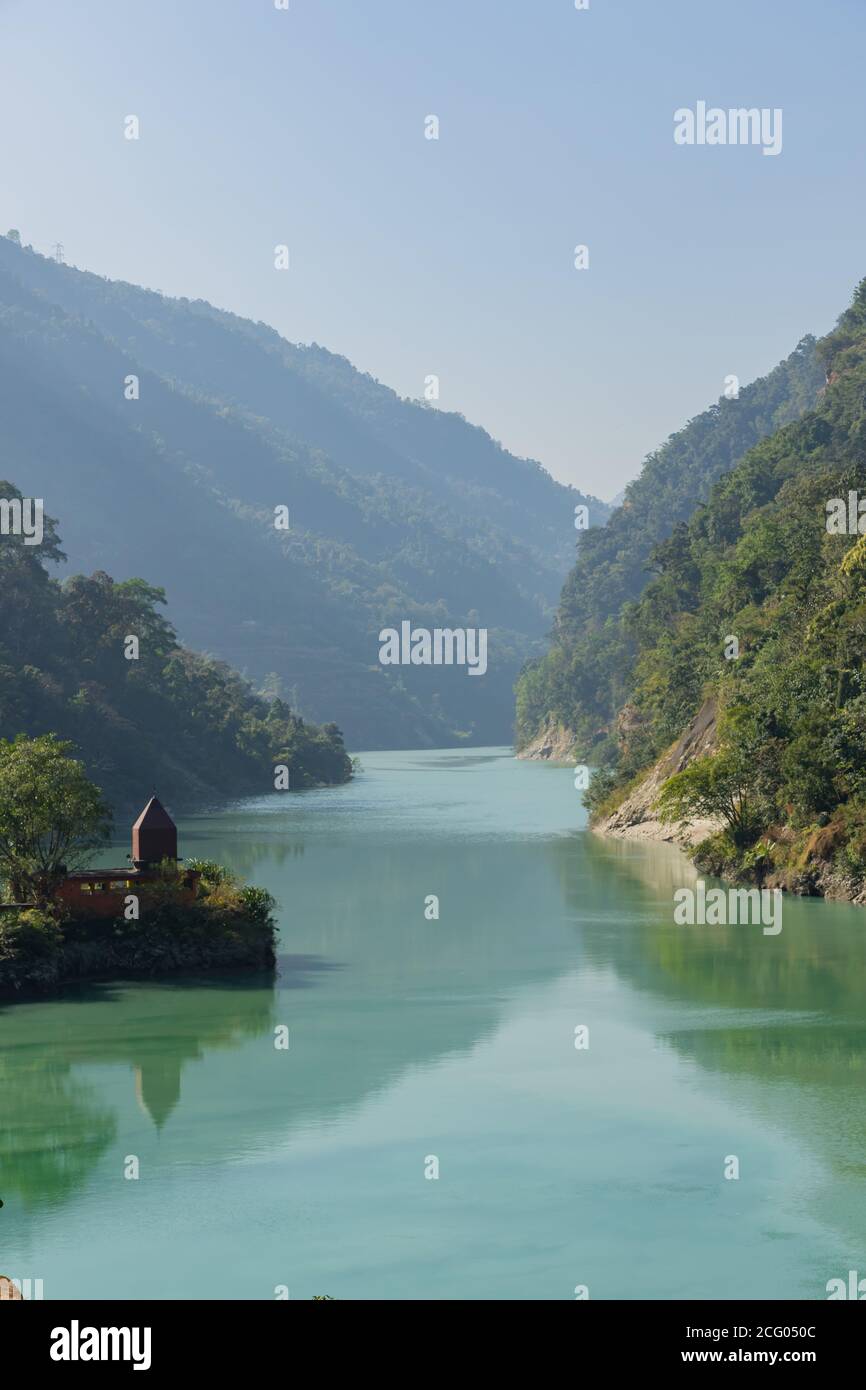 Teesta river flowing down from Sikkim to Darjeeling district with lush green hills and mountains on both sides Stock Photo