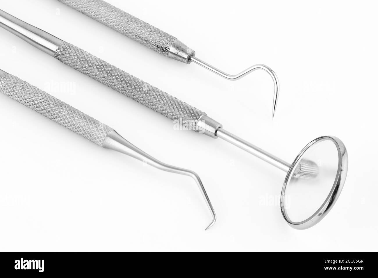 Dentist's tools inclined on a white background Stock Photo