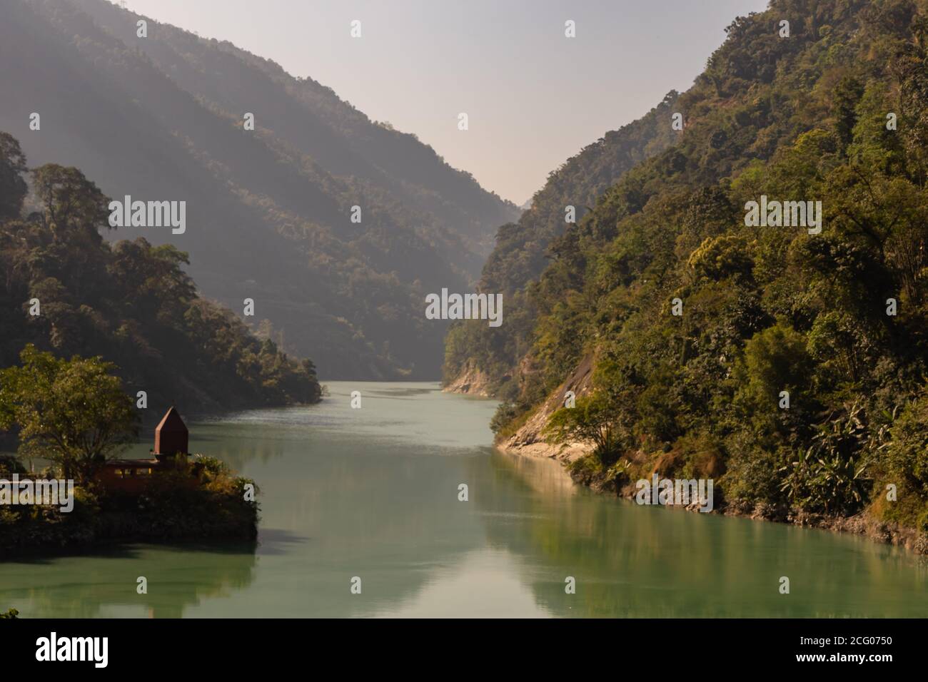 Teesta river flowing down from Sikkim to Darjeeling district with lush green hills and mountains on both sides Stock Photo