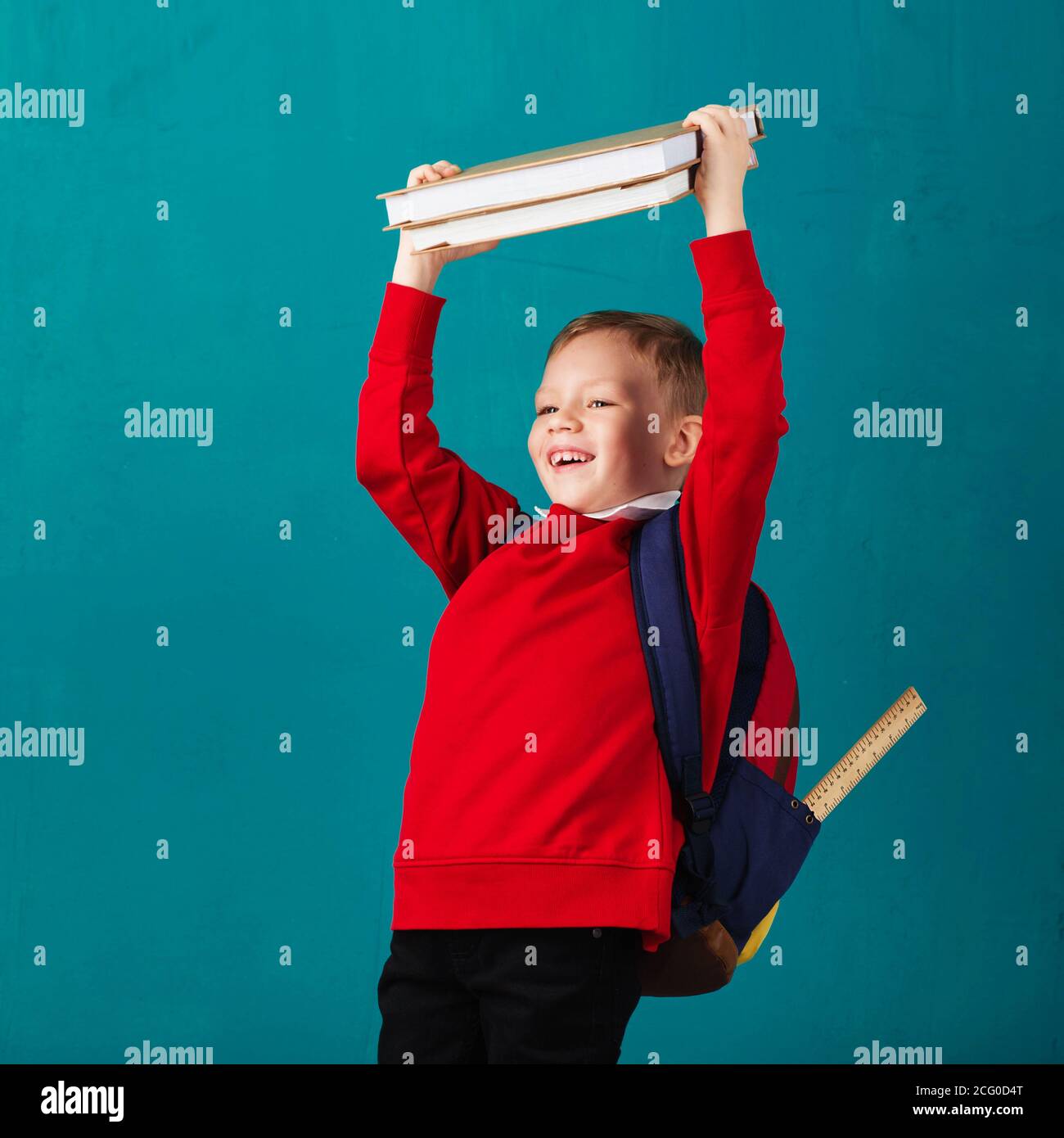 Cheerful thoughtful little school boy in school uniform with backpack ...