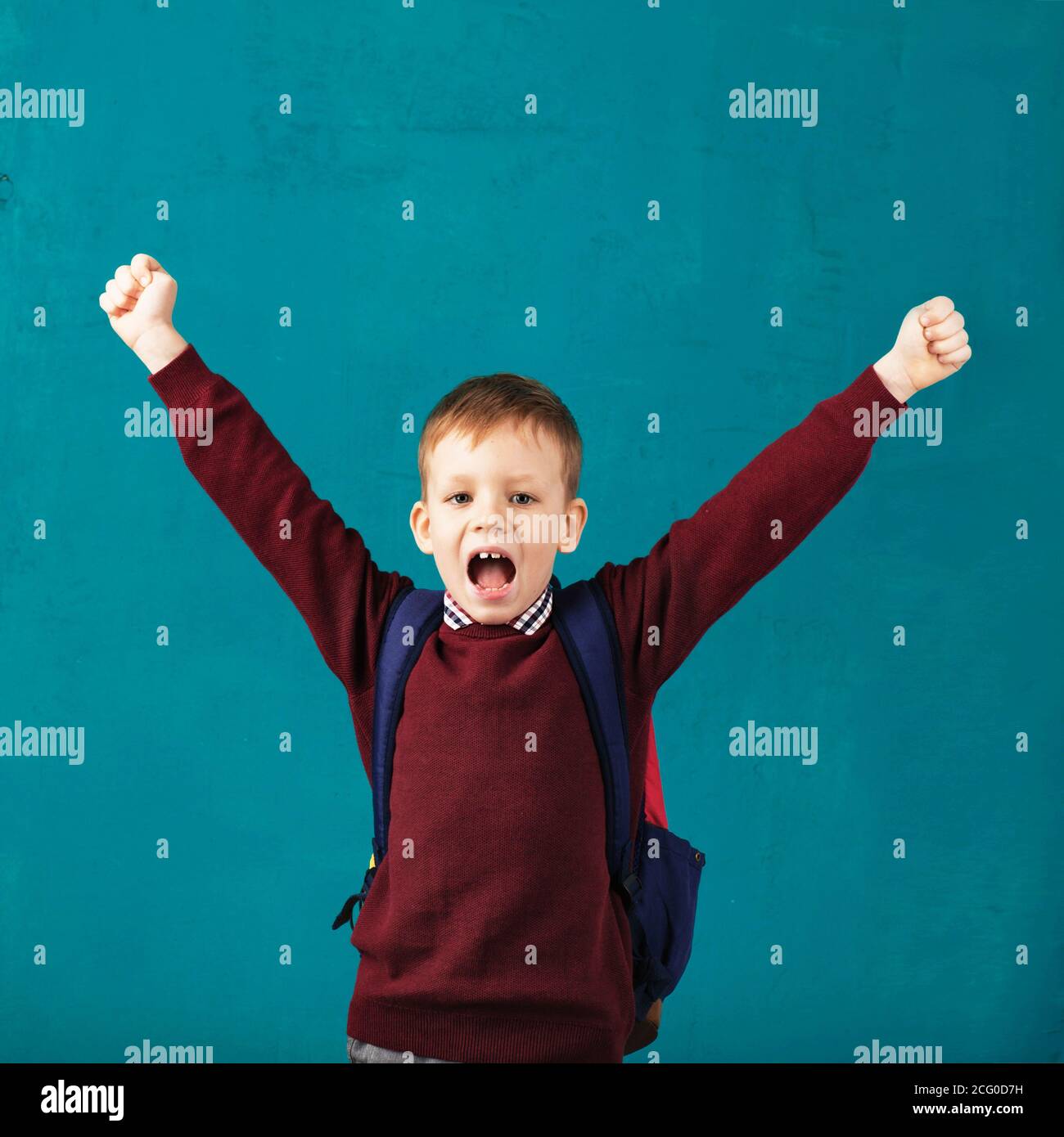 Cheerful smiling little school boy with big backpack jumping and having ...