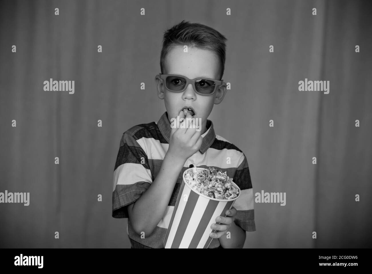 Home theater. Cute Child in vintage cinema eyeglasses. Entertainment concept. Vintage Black and white photography Stock Photo
