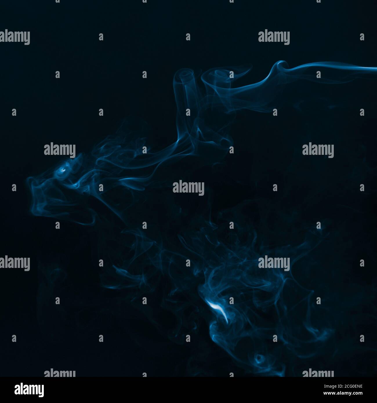 Beautiful blue smoke against dark background Stock Photo