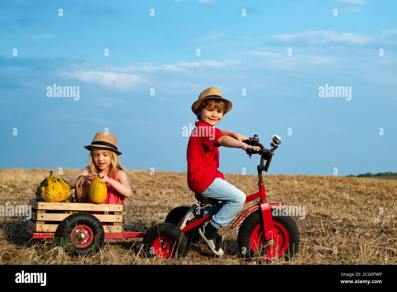 Positive little girl and boy. Beautiful fun day for cute friends in nature. Little girl and boy enjoy life and nature. Little cute kids is smiling Stock Photo