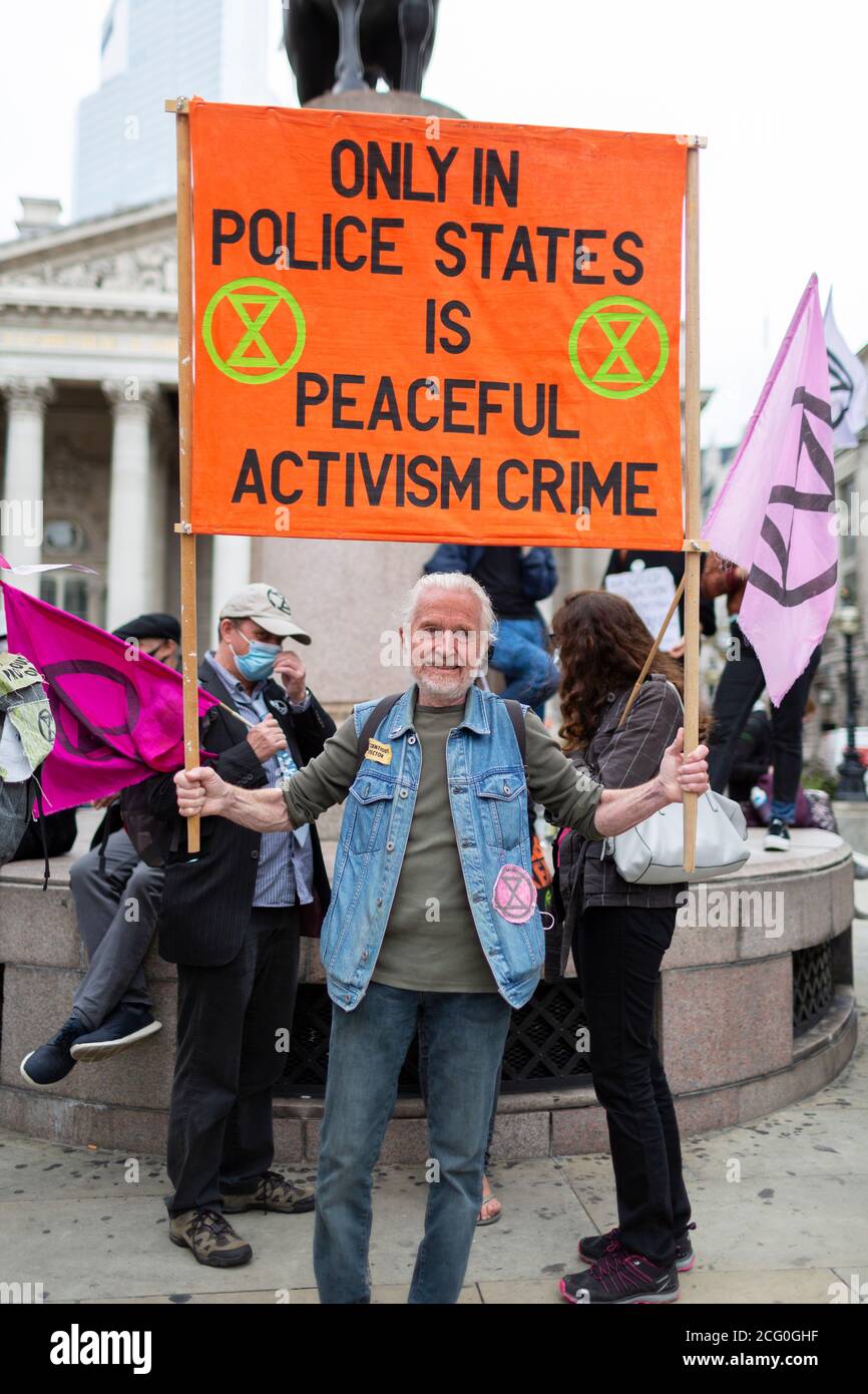Elderly protester with sign, 'Walk of Shame' Extinction Rebellion demonstration, Bank of England, London, 4 September 2020 Stock Photo