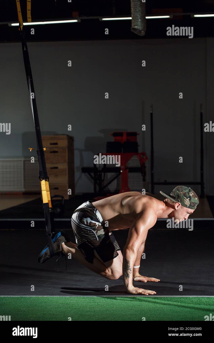 male and athletic male doing trx straps exercises in a gym club Stock ...