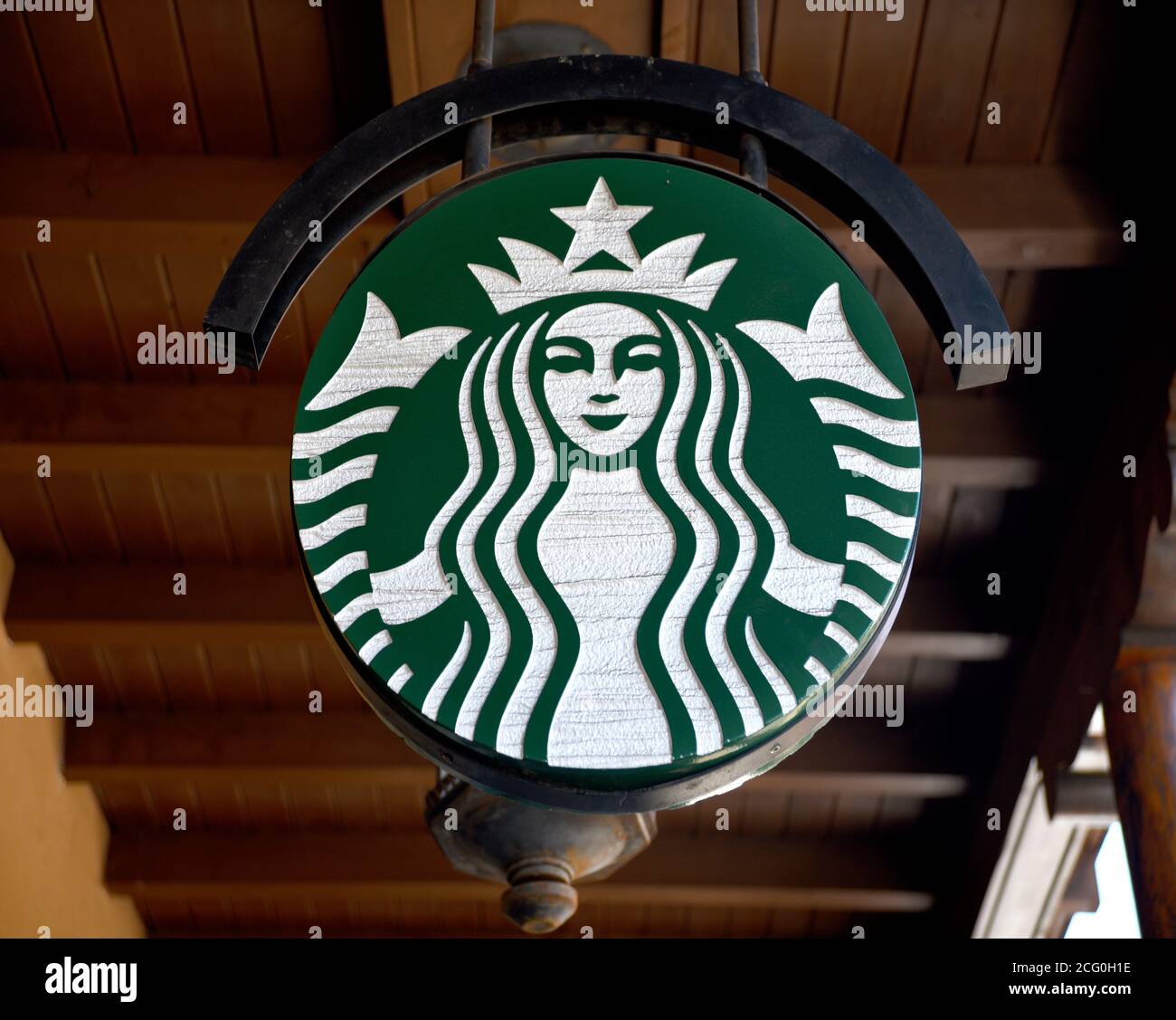 A business sign with the Starbucks Coffee logo hangs over a Starbucks Coffee shop in Santa Fe, New Mexico. Stock Photo
