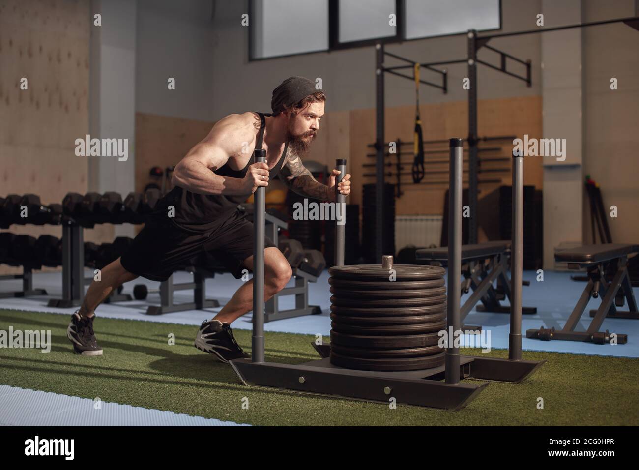 Fitness sled push man pushing weights workout exercise Stock Photo Alamy
