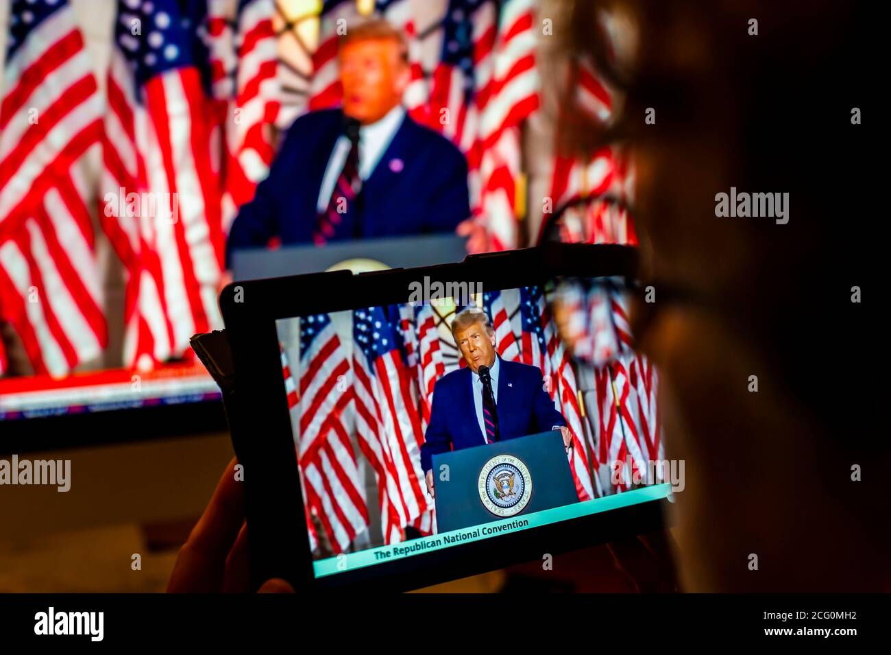 A voter watches President Donald Trump give his acceptance speech at the virtual Republican National Convention on Thursday, August 27, 2020. (© Richard B. Levine) Stock Photo