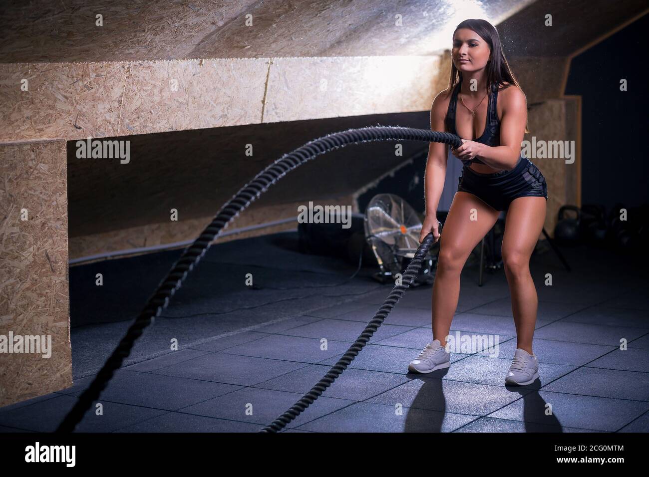 Flying Ropes Girl battling ropes girl at gym workout exercise fitted body Stock Photo - Alamy