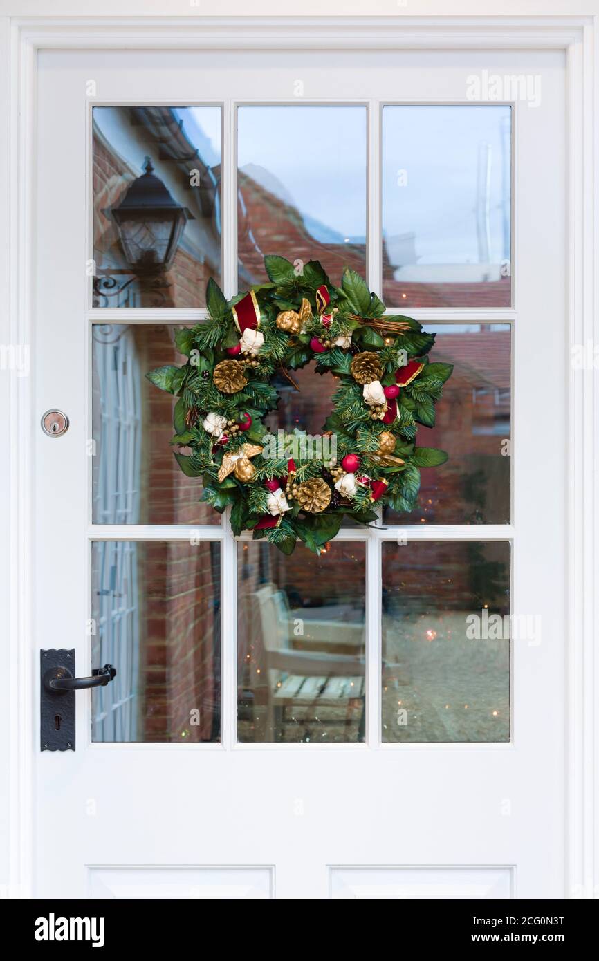 Entrance front door with Christmas wreath of a house in UK at winter Stock Photo