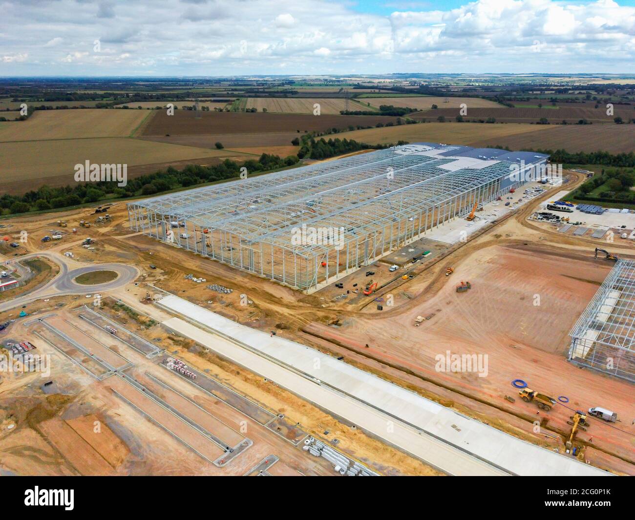 Construction is well underway in September 2020 of the Co-op food group new regional distribution centre at Symmetry Park, Biggleswade, Bedfordshire, UK The main framework for the warehouse hub of 661,000 sq ft seen here from the air. Stock Photo