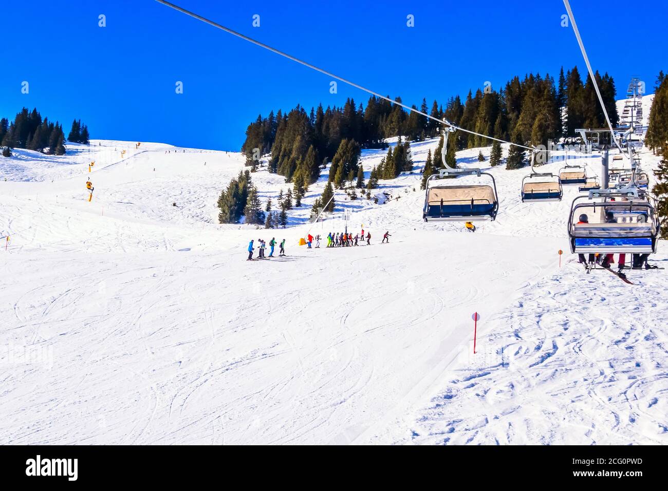 Saalbach, Austria panorama ski lift and skiers at ski slope of austrain winter resort Stock Photo