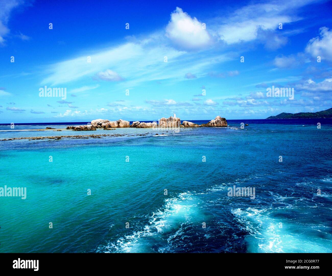 Indian ocean near Seychelles island.Azure watercolor. Crystal clear sea water. Stunning seascape. Scenic rocky coast.Tropical summer.Turquoise surface Stock Photo