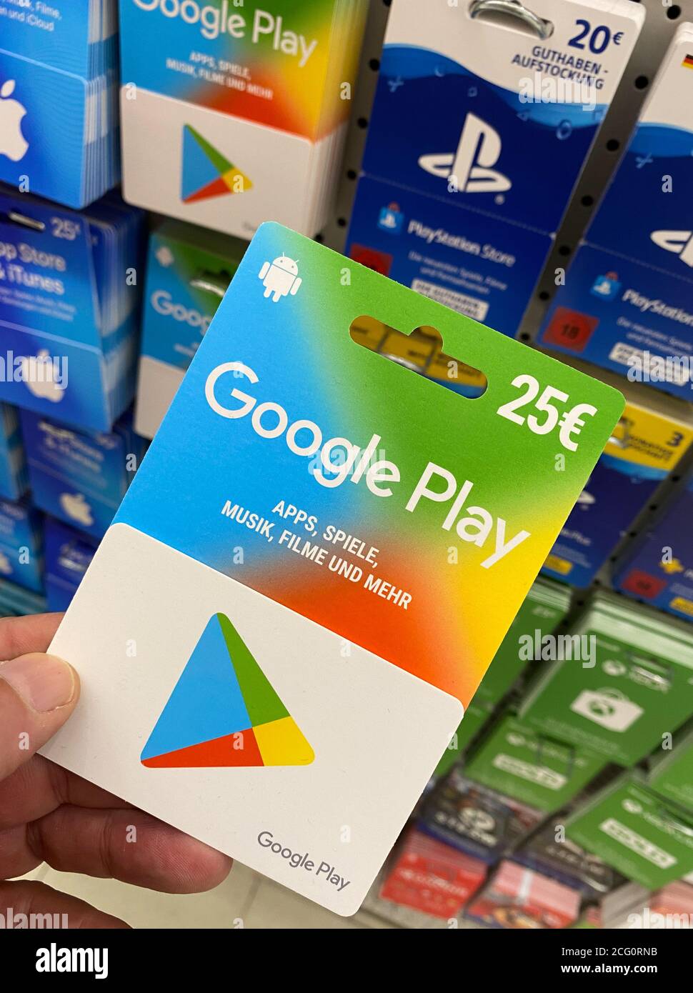 Viersen, Germany - July 9. 2020: View on google play gift voucher card hold by hand in german supermarket (focus on card) Stock Photo