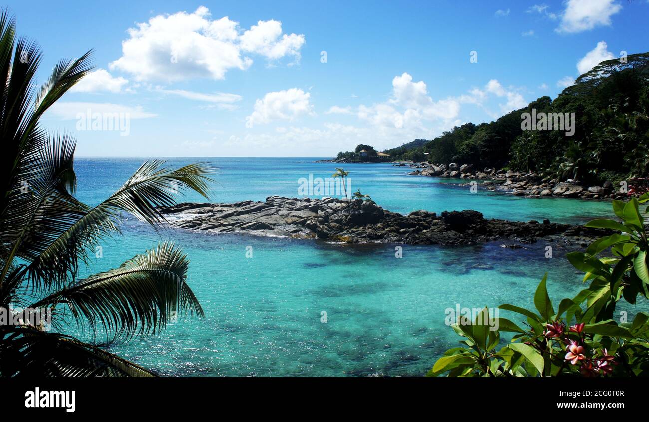 Tropical Seychelles Islands in turquoise Indian ocean. Beautiful landscape of exotic nature. Azure blue sea. Paradise beach. Green palms. Rocky beach. Stock Photo