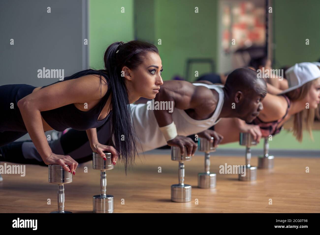 Side view of a group of fitness people doing push ups Stock Photo - Alamy