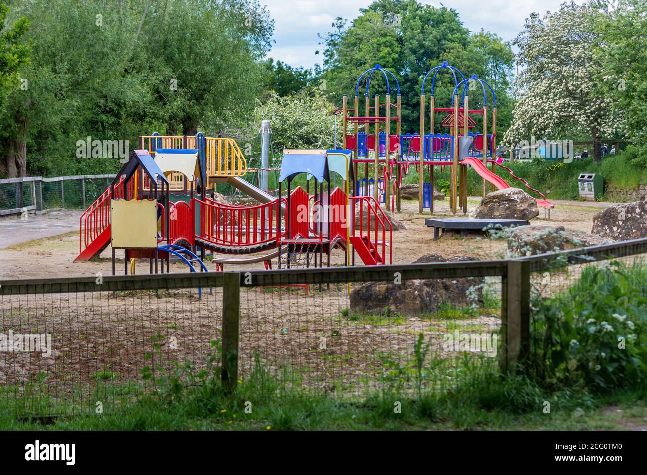 Outdoor play equipment including slides and climbing apparatus in