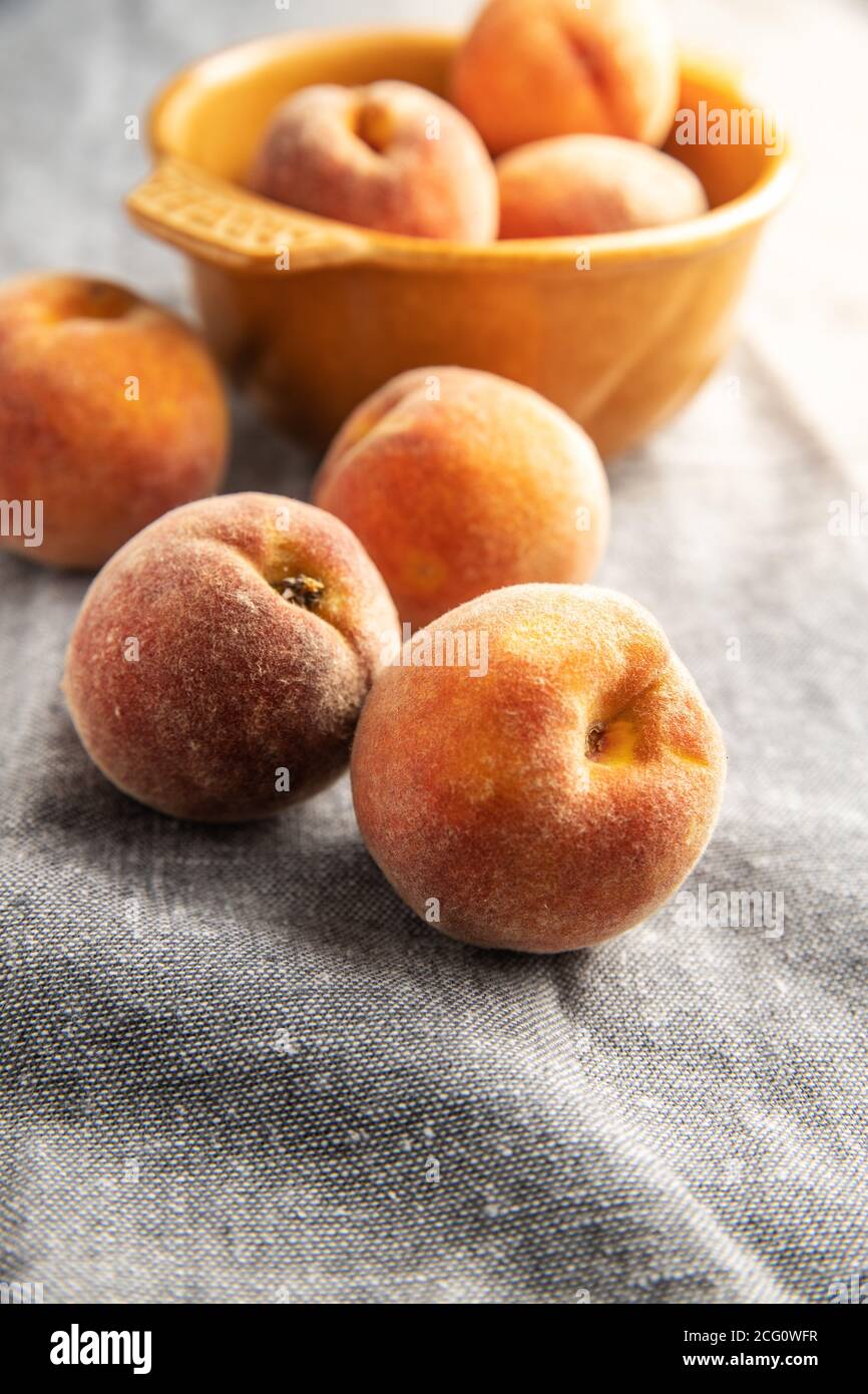 Fresh ripe bio peaches on tablecloth. Stock Photo