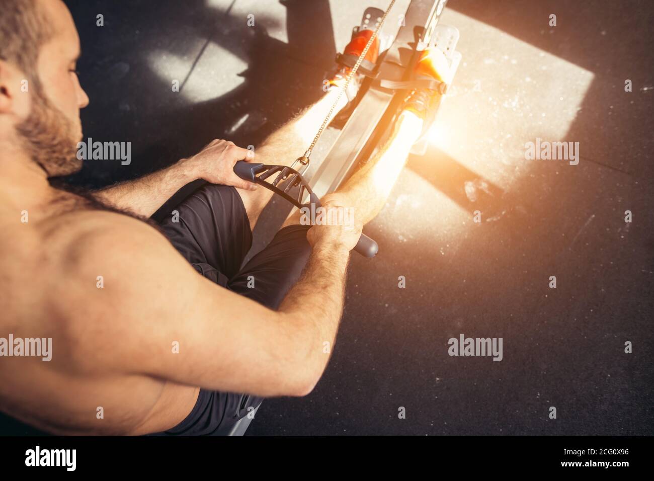 sporty male workouts on power exercise machine in a gym club Stock Photo