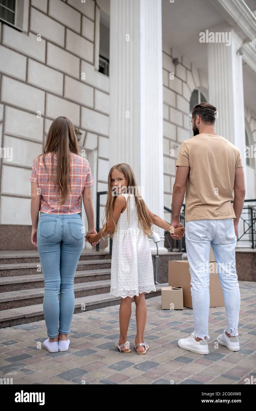 Young family standing near their new house Stock Photo - Alamy