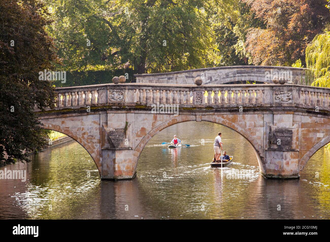People and families punting on the river Cam by the Clare College Bridge   in the Cambridgeshire city of Cambridge England Stock Photo