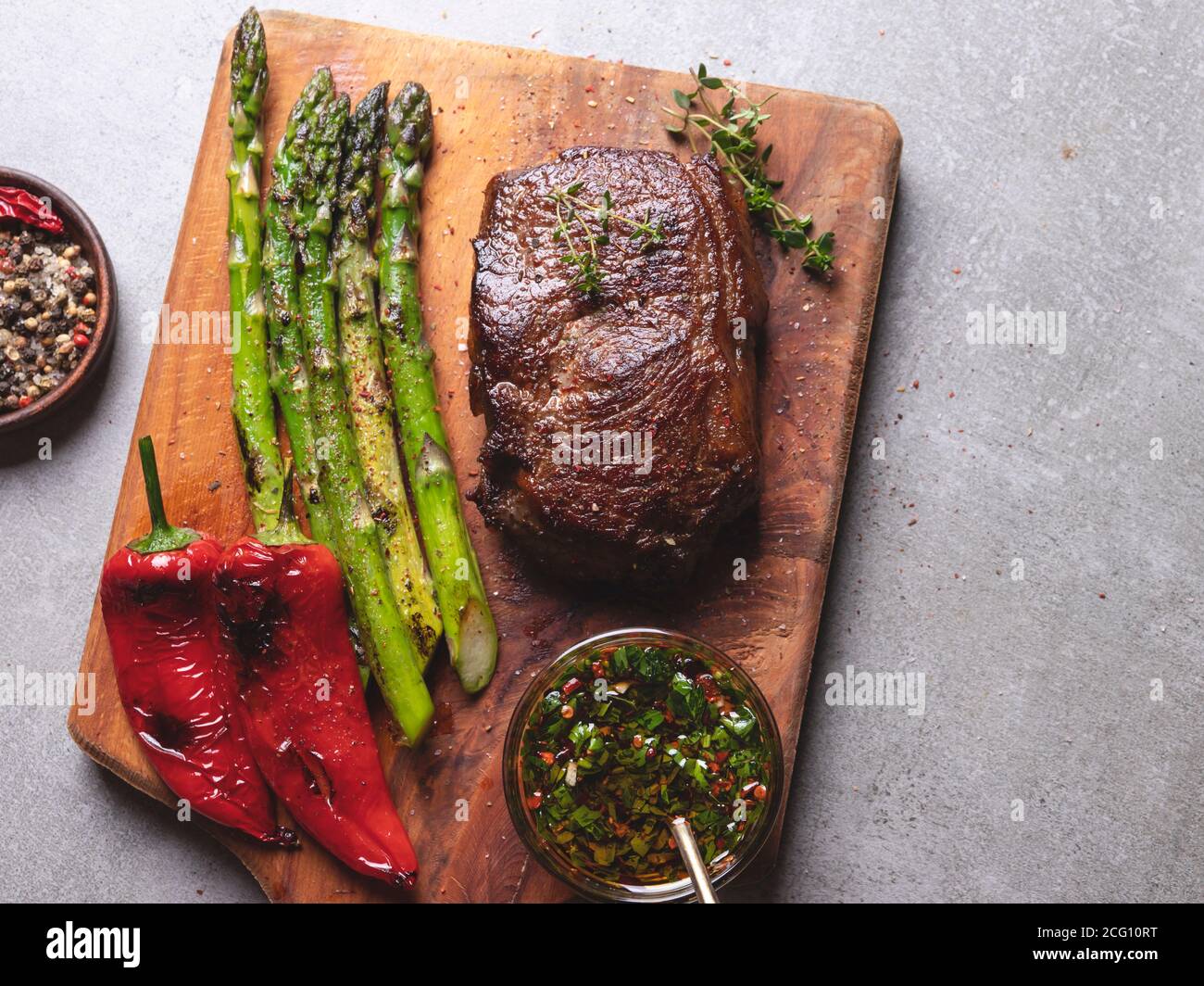 juicy roasted meat steak with asparagus, pepper, sauce, close up Stock