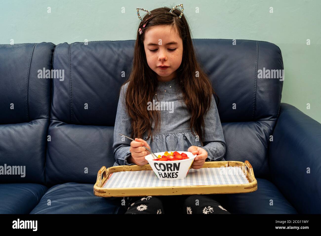 Young girl not wanting to eat breakfast Stock Photo