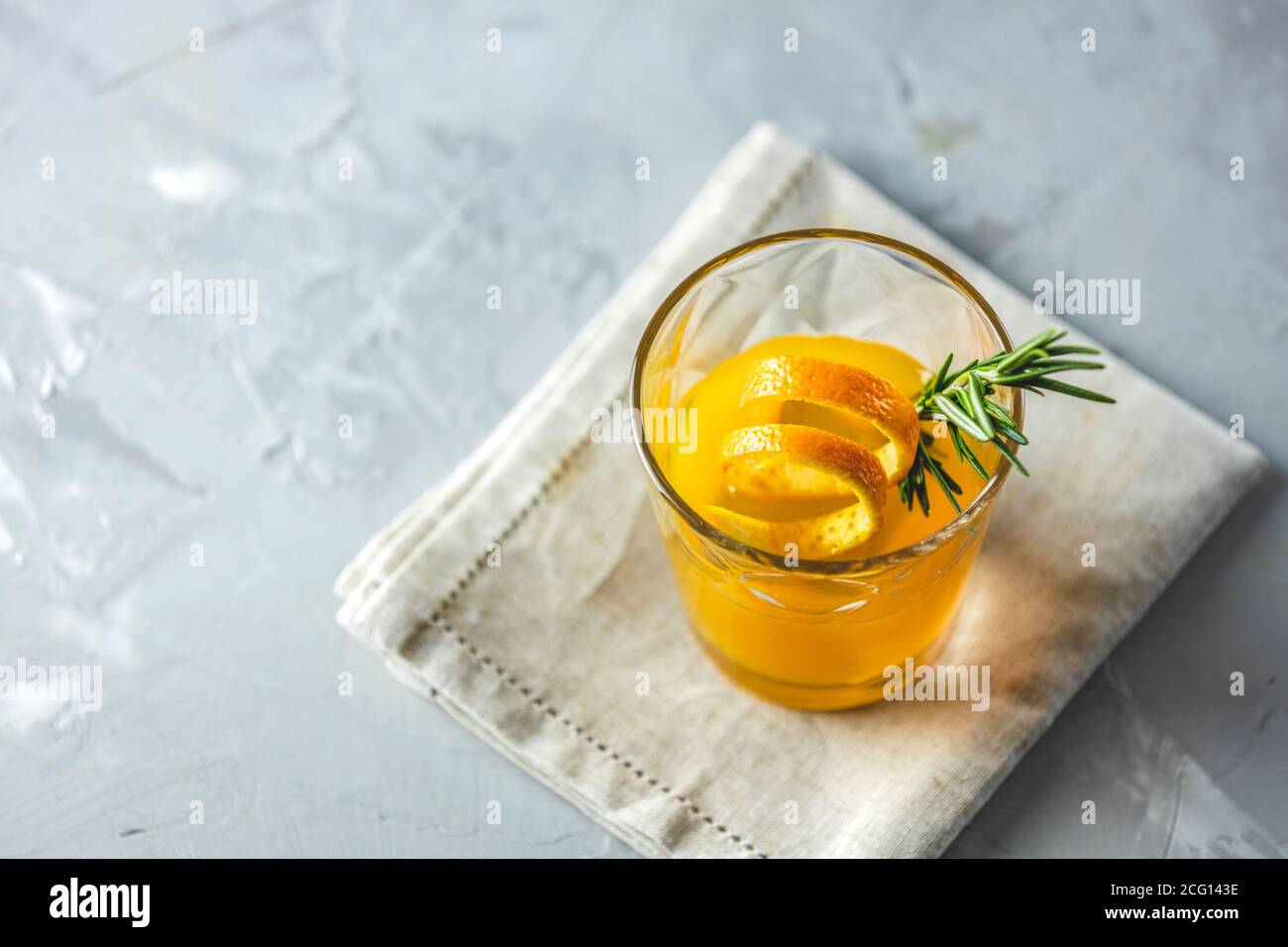 Glass of honey bourbon cocktail with rosemary simple syrup or homemade