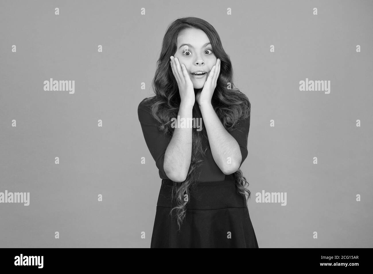 Surprise for her. Surprised girl brown background. Little child with facial expression of surprise. Small kid feel surprise. Shocking news. Taken by surprise. Stock Photo