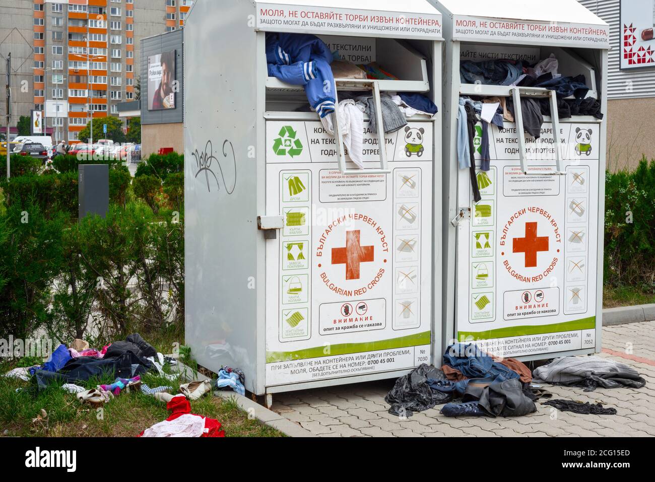 Over floating Red Cross charity community clothing donation bin container  bank and scattered clothes on the ground in Sofia Bulgaria as irresponsible  and ugly act Stock Photo - Alamy