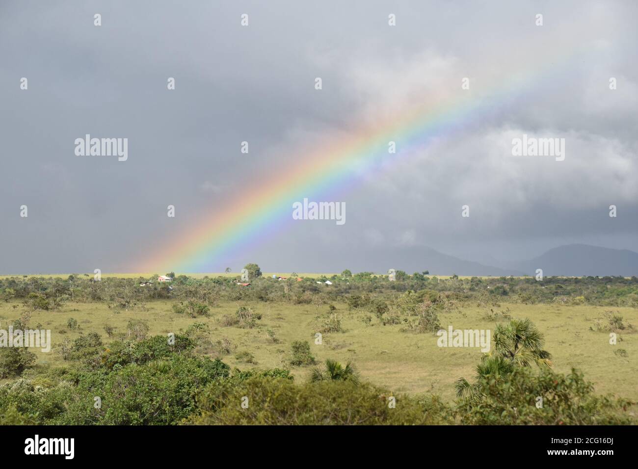 Rainbow and field at Cerrado Brazil Stock Photo