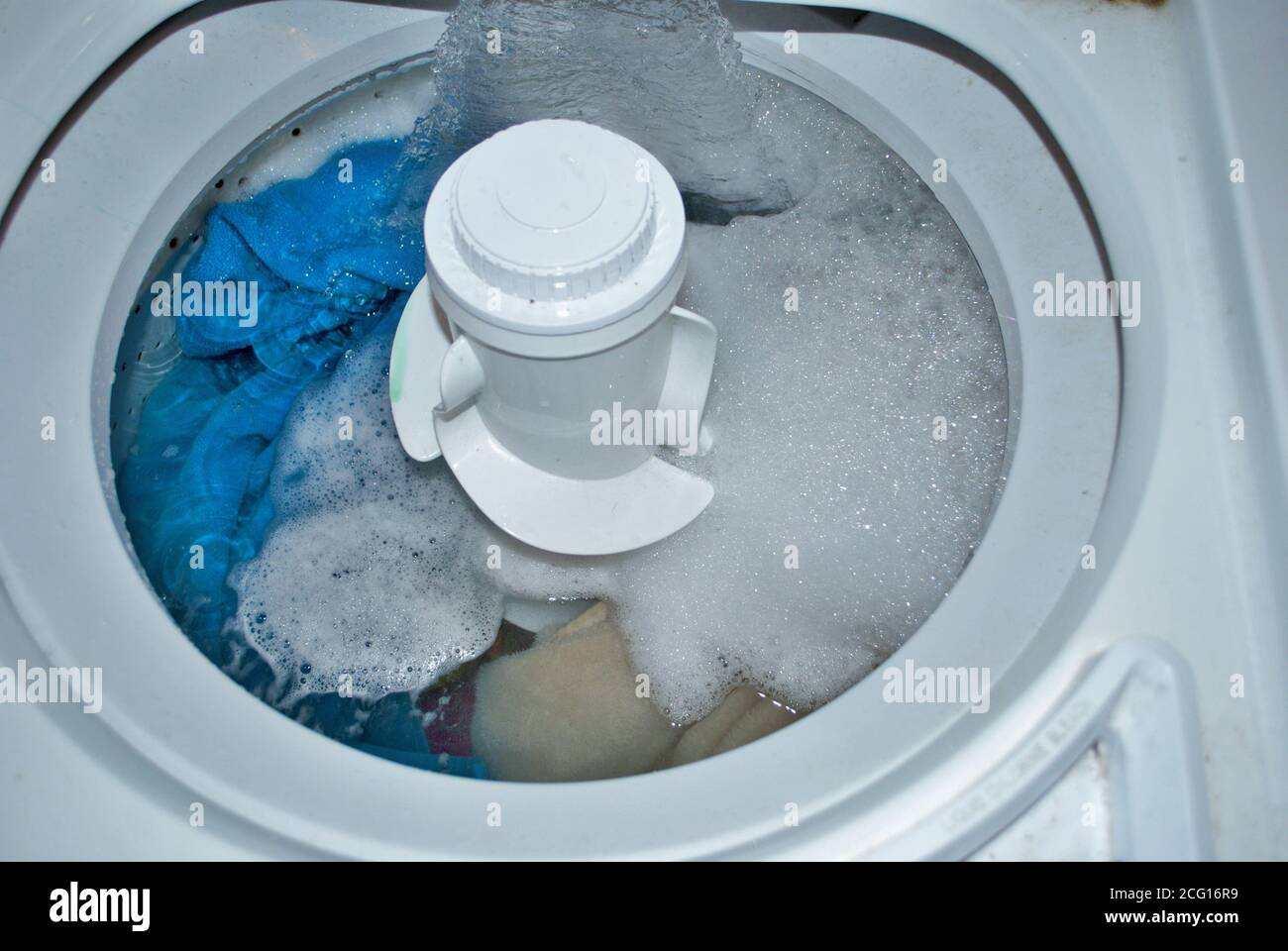 load of dirty towels in a washing machine filling with water Stock ...