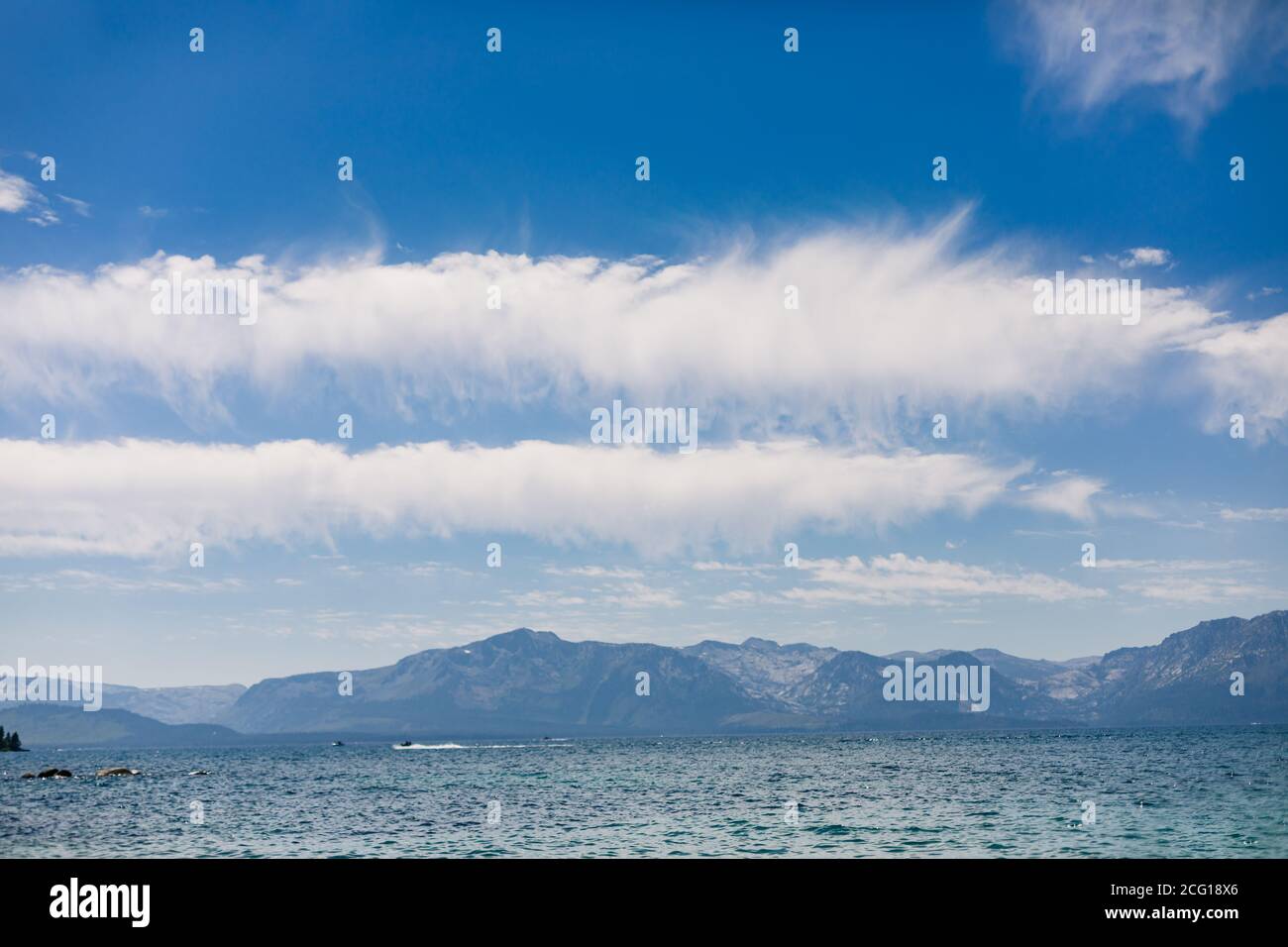 Clouds in a Blue Sky above a Blue Mountain Lake Stock Photo - Alamy