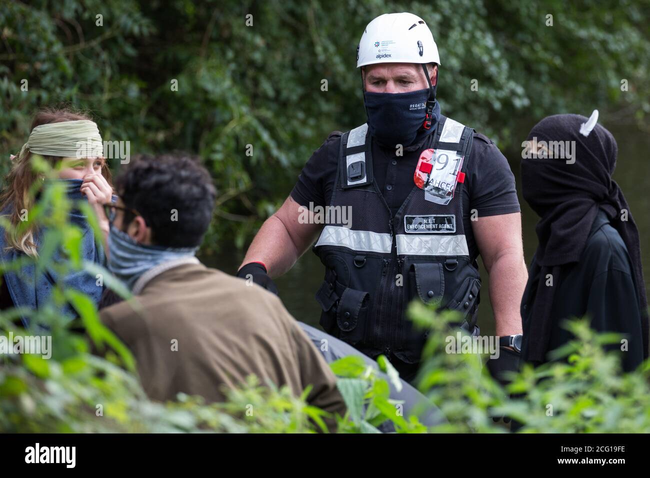 Denham, UK. 7th September, 2020. National Eviction Team enforcement agents try to prevent activists from HS2 Rebellion from interrupting tree cutting in conjunction with the HS2 high-speed rail link in Denham Country Park. Anti-HS2 activists continue to try to prevent or delay works on the controversial £106bn project for which the construction phase was announced on 4th September from a series of protection camps based along the route of the line between London and Birmingham. Credit: Mark Kerrison/Alamy Live News Stock Photo