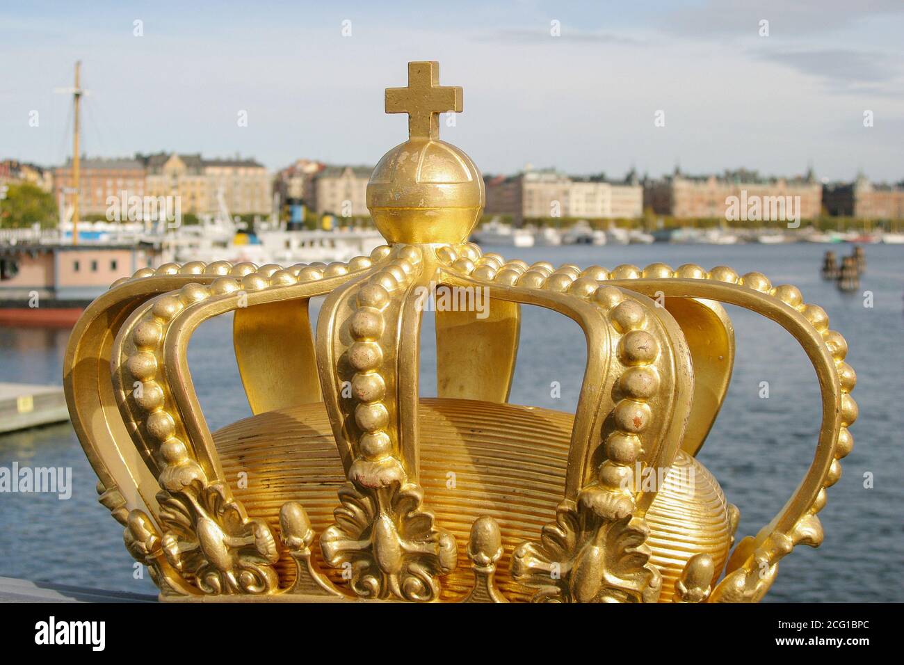 Royal symbol Sweden, a painted gold crown on Skeppsholmbron Stockholm on sunny day. Stock Photo