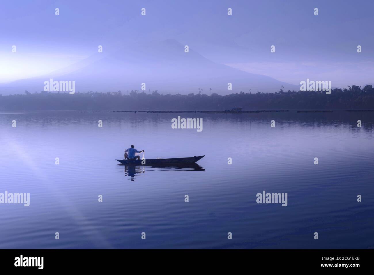 lone fisherman in a misty morning at a lake, Sampaloc, Lake, San Pablo City, Laguna, Philippines Stock Photo
