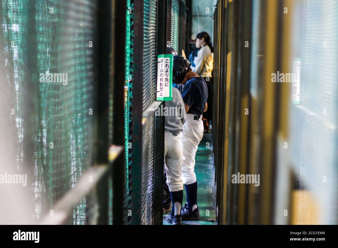Japanese people waiting in line at a batting cage Stock Photo