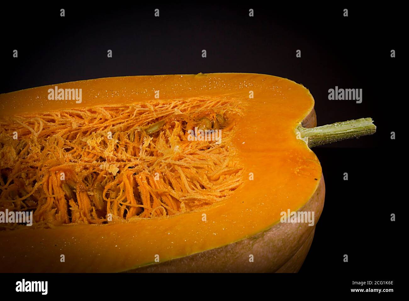 Cut ripe orange pumpkin on black background Stock Photo - Alamy