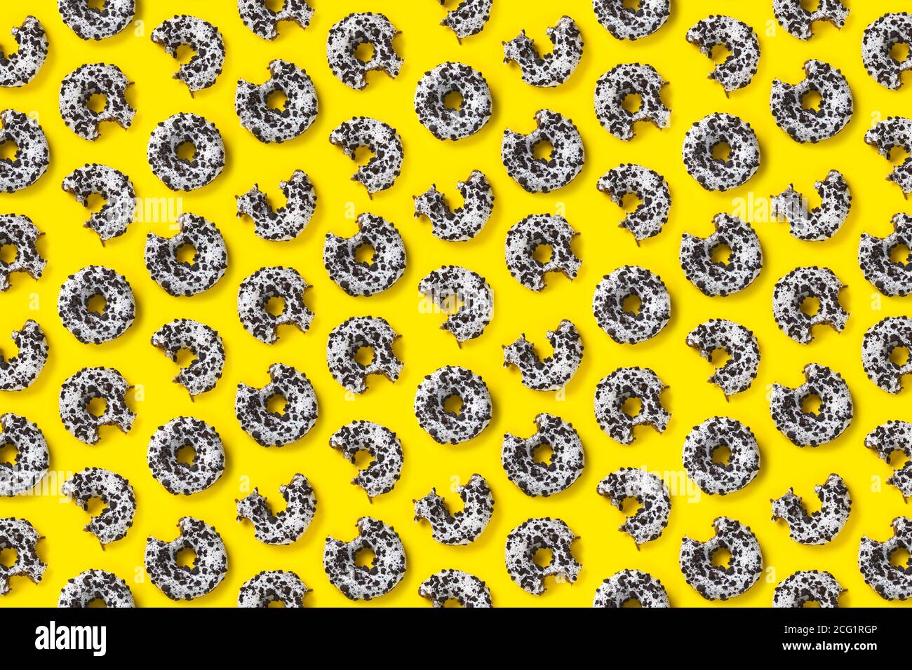 donuts on a yellow background top view. Flat lay of delicious nibbled ...