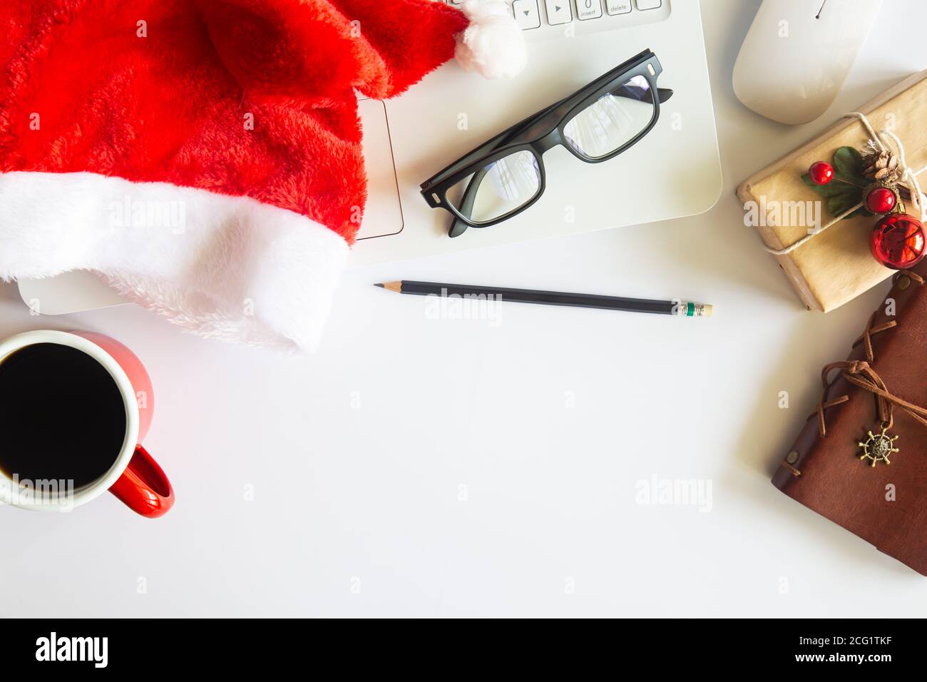 White Christmas, desk office with laptop, decoration and work supplies with cup of coffee. Top view with copy space for input the text. Flat lay desk Stock Photo