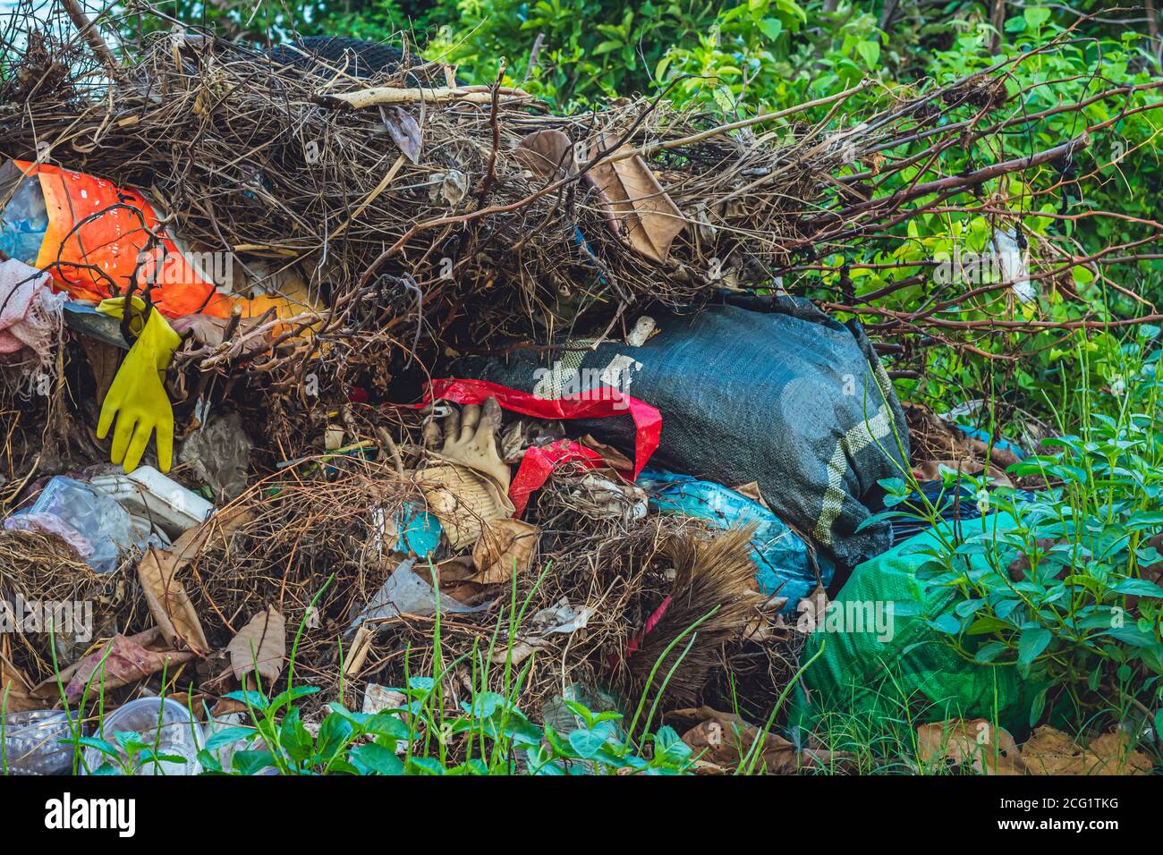Spilled recycling man made garbage in park forest near city. Empty used