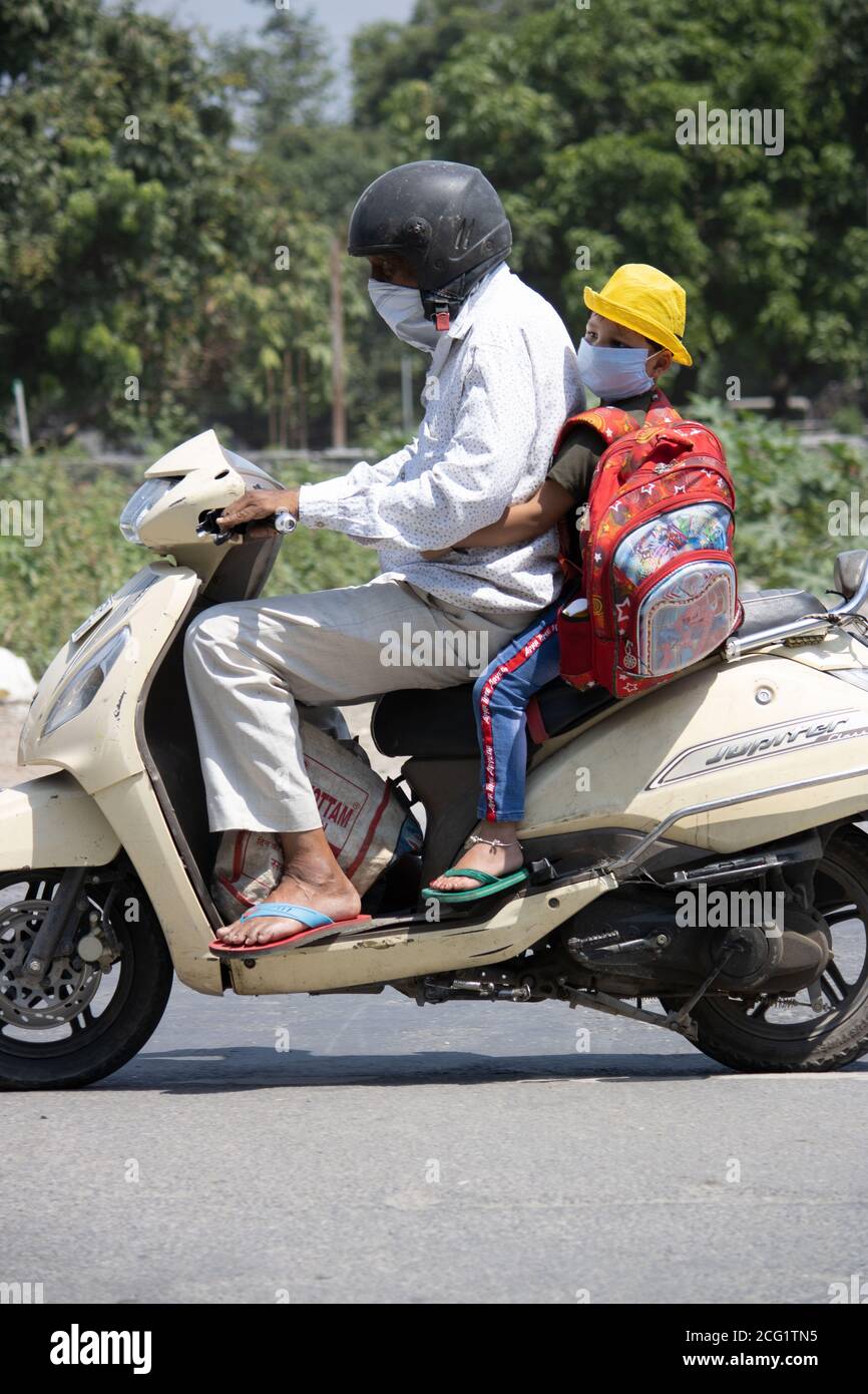 A man with a child on a scooter hi-res stock photography and images - Page  4 - Alamy