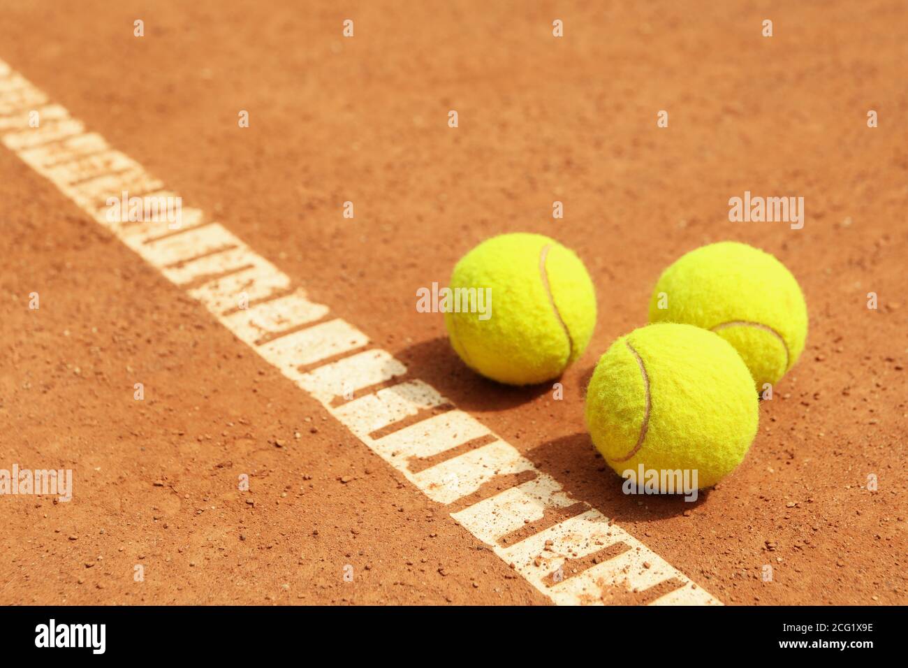 Light green tennis balls on clay court Stock Photo Alamy