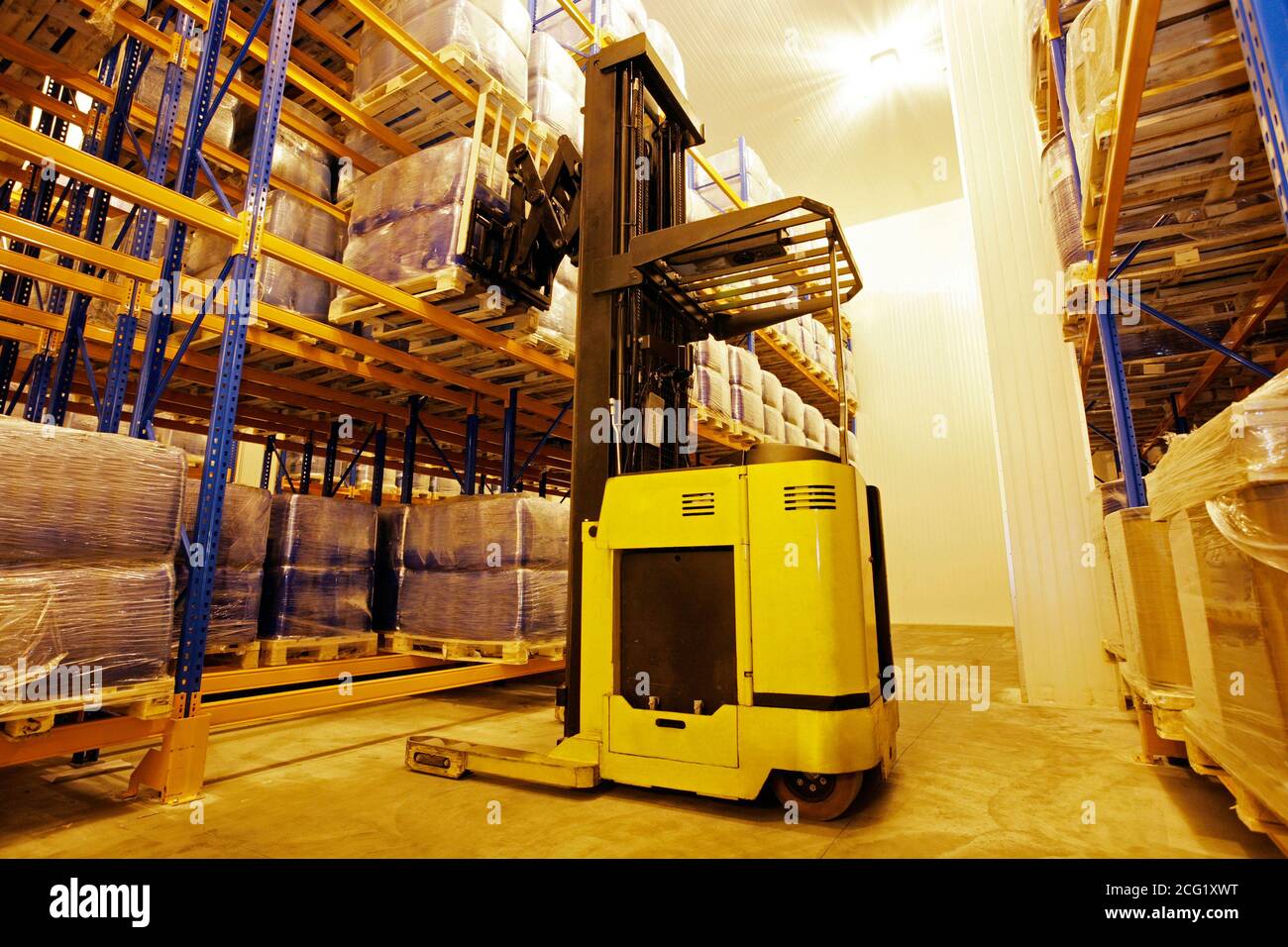 Warehouse storage with yellow forklift Stock Photo