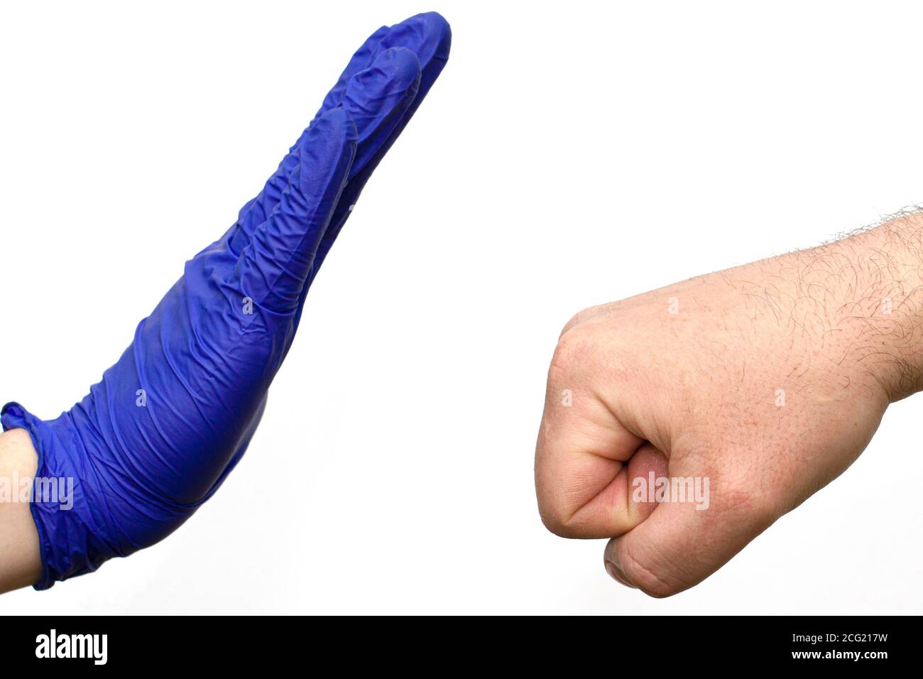 hand of a man in a blue medical glove stops an unprotected hand