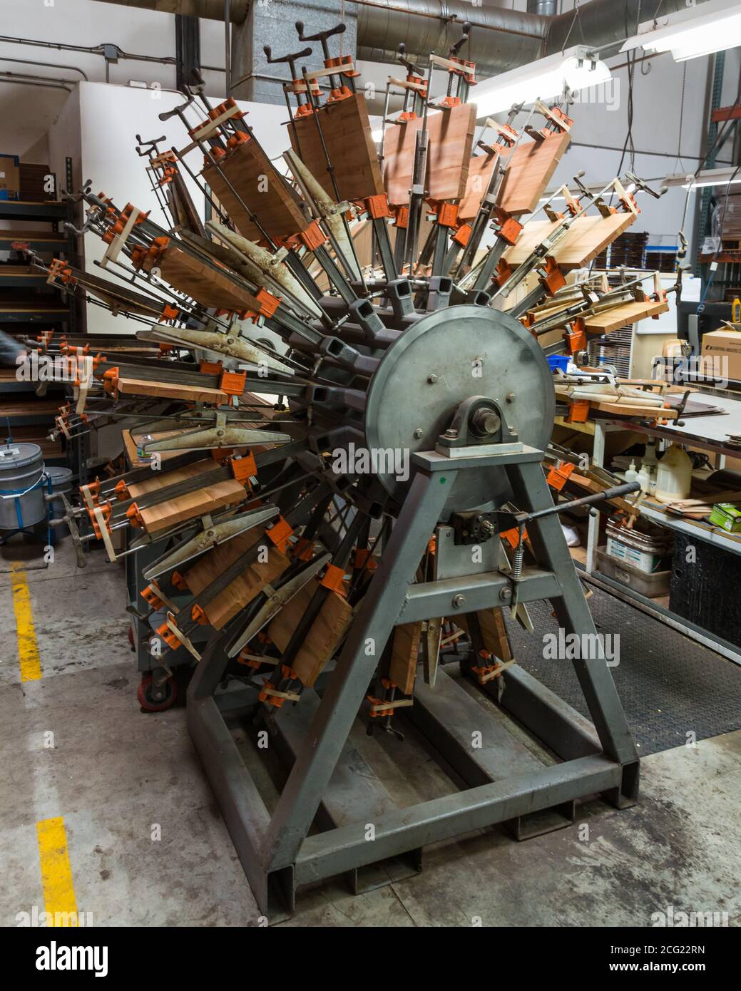 A special rotating clamping machine for holding glued wood parts in the Taylor Guitar factory in El Cajon, California. Stock Photo